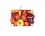 Fresh tasty red and yellow vegetables in wooden crates on white background