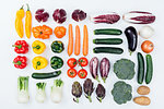 Fresh tasty seasonal vegetables on white background, healthy eating concept, flat lay