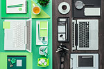 Customized office workspace: green eco-friendly desktop on one side, standard and monochromatic on the other side