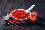 red hot sweet chilli sauce over old wooden background