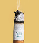 Cigarette burning on yellow background, stop smoking concept