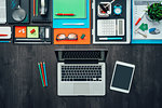 Creative business desktop with laptop, office accessories and colored pencils, flat lay
