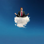 Stressed businessman practice yoga on a cloud in the sky