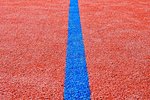 Blue line on red playing field. Copy space. Sport texture and background.