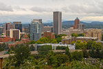 Portland Oregon downtown cityscape by freeway nestled among trees