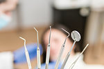 Set of dentist tools on a blurred background of a dental office