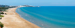 Summer Lido di Portonuovo Adriatic sea beach view (Vieste, Gargano peninsula, Puglia, Italy). People are unrecognizable. Two shots stitch panorama.