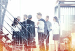 Business people work together in office with skyscraper on background with internet network effects. Concept of teamwork and partnership. double exposure