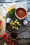 Fresh italian  pizza  ingredients on wood. Pizza with cheese, salami and tomatoes. Fast food. Rustic pizza