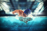 Young athlete trains swimming in the pool