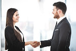 Business people shaking hands, finishing up a meeting in the office