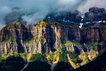 Close-up of sunlit Mondarruego mountain with mist in the Pyrenees in Ordesa y Monte Perdido National Park in Huesca Province in Aragon, Spain