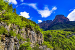 Looking up at rock cliffs and mountain top against a blue sky in Ordesa y Monte Perdido National Park in the Pyrenees in Huesca Province, Aragon, Spain