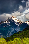 Snow capped mountain top with dark cloud in the Pyrenees in the Ordesa y Monte Perdido National Park in Huesca, Aragon, Spain