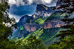 Looking through the tres at sunlit forest on the mountains in the Pyrenees in the Ordesa y Monte Perdido National Park in Huesca Provnce, Aragon, Spain