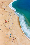 Sandy beach and ocean surf along the coastline of Nazare in the Leiria District of Oeste in Portugal