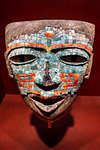 Close-up of an ancient, mosaic sculpture of a face in the National Museum of Anthropology (Museo Nacional de Antropologia), Mexico City, Mexico