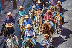 Cowboys on horseback, riding in parade to the Parroquia de San Miguel Arcangel in St Michael Archangel Festival, San Miguel de Allende, Mexico