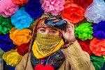 Close-up of indigenous tribal dancer wearing mask and colurful flowers at a St Michael Archangel Festival parade in San Miguel de Allende, Mexico