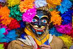 Close-up of indigenous tribal dancer wearing mask and colurful flowers at a St Michael Archangel Festival parade in San Miguel de Allende, Mexico