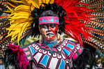 Indigenous tribal dancer wearing colorful headdress at a St Michael Archangel Festival parade in San Miguel de Allende, Mexico