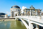 Government buildings of the Financial Police Officeon the left as well as the Ministry of Foreign Affairs building on the right with the Art Bridge crossing the Vardar Rivr in Skopje, Macedonia