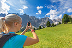 Girl takes a photo with a smartphone, Longiaru, Badia Valley, South Tyrol, Dolomites, Italy, Europe