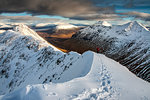 A female walker approaching the summit of Stob Dubh on Buchaille Etive Beag on a crisp winter day, Highlands, Scotland, United Kingdom, Europe