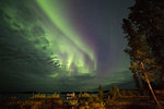 The Northern Lights (aurora borealis) in the night sky above Lake Egenolf in northern Manitoba, Canada, North America