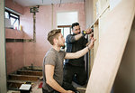 Construction workers framing inside of house