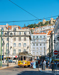 Traditional yellow tram at Praca da Figueira with Castelo Sao Jorge at background, Lisbon, Portugal, Europe