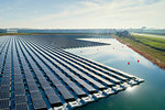 Floating solar panels installed on water supply of neighbouring greenhouses, elevated view, Netherlands