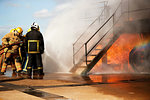 Firemen training, firemen spraying water at training facility stairway