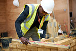 Lecturer building brick wall in classroom