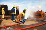 Firemen training to put out fire on burning tanks, Darlington, UK