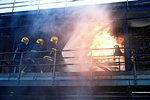 Firemen training to put out fire on burning building, Darlington, UK