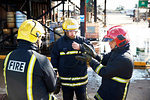 Firemen in discussion in training centre, Darlington, UK