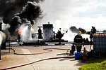 Firemen training to put out fire on burning tanks, Darlington, UK