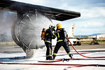 Firemen putting out fire on old training aeroplane, Darlington, UK