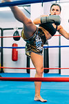 Female boxer practising in boxing ring