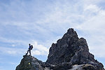 Hiker on peak of rock, Mont Cervin, Matterhorn, Valais, Switzerland