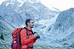 Hiker using binoculars, Mont Cervin, Matterhorn, Valais, Switzerland