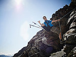 Hiker using rope to ascend rock face, Mont Cervin, Matterhorn, Valais, Switzerland