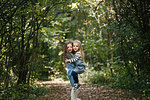Sisters hugging in forest