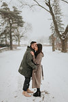 Couple hugging in snowy landscape, Georgetown, Canada