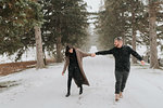 Couple walking in snowy landscape, Georgetown, Canada