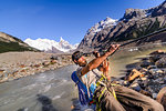 Rock climber sliding on rope over river, El Chaltén, south Patagonia, Argentina