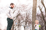 Father watching over son in park