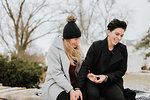 Couple sitting on blanket on low wall