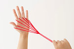 Japanese woman playing with red string